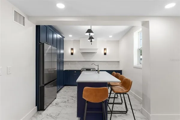 a kitchen with stainless steel appliances a sink cabinets and wooden floor