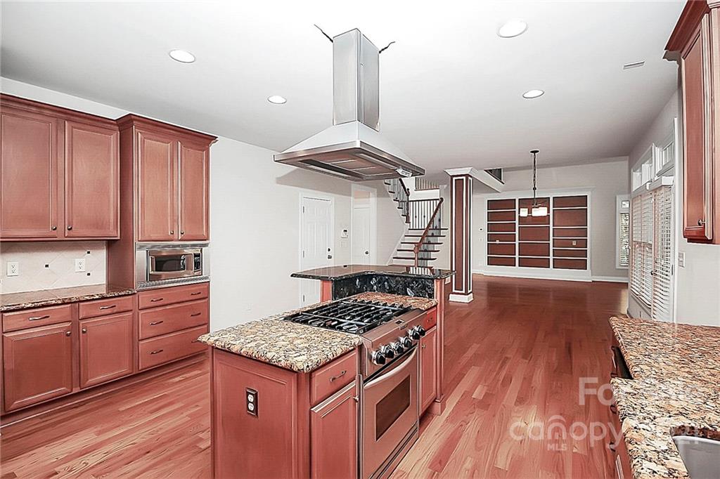 4080 Crepe Ridge Drive Denver, NC 28037 - Photo 14 of 34 a kitchen with granite countertop a stove and a wooden floors