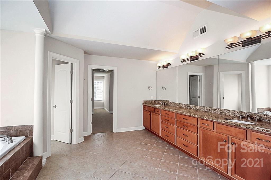4080 Crepe Ridge Drive Denver, NC 28037 - Photo 21 of 34 a spacious bathroom with a granite countertop sink a mirror and a shower