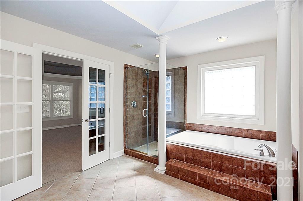 4080 Crepe Ridge Drive Denver, NC 28037 - Photo 22 of 34 a spacious bedroom with a bed and a window