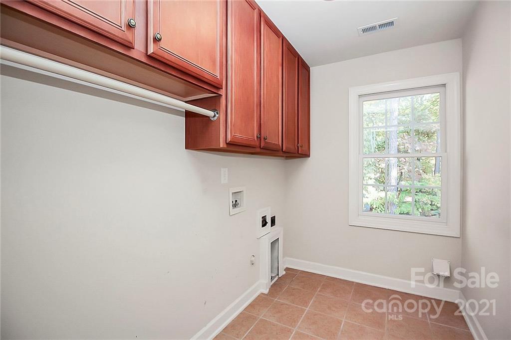 4080 Crepe Ridge Drive Denver, NC 28037 - Photo 25 of 34 a view of a kitchen with wooden floor and cabinets
