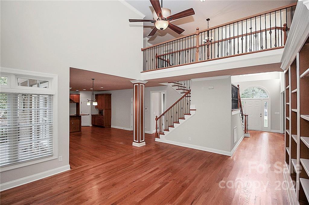 4080 Crepe Ridge Drive Denver, NC 28037 - Photo 8 of 34 a view of a hallway with wooden floor and staircase