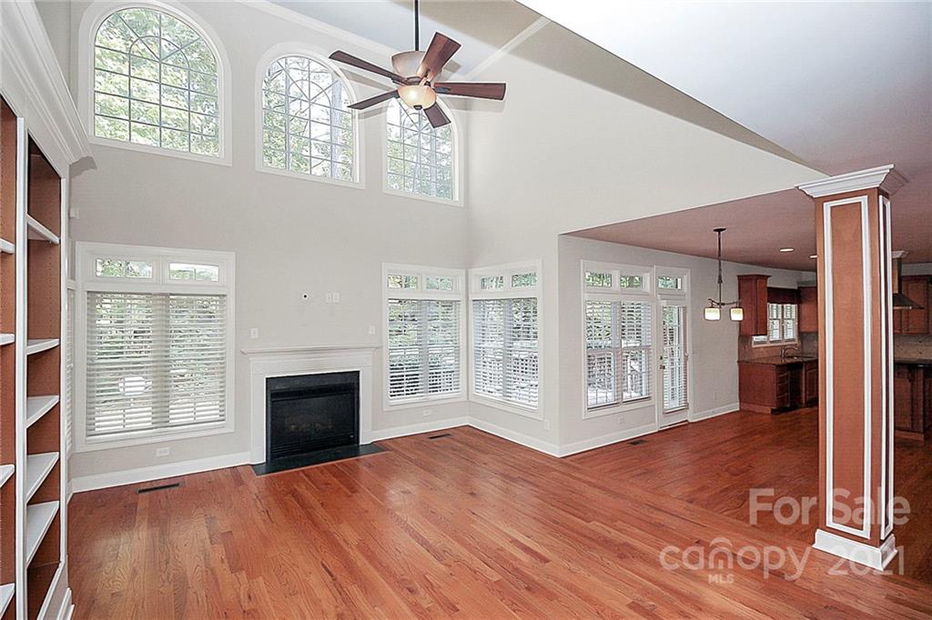 4080 Crepe Ridge Drive Denver, NC 28037 - Photo 10 of 34 an empty room with windows fireplace and wooden floor