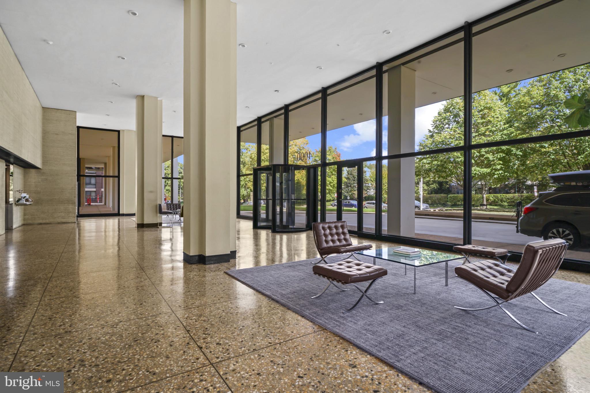 4000 North Charles Street, Unit 706 Baltimore, MD 21218 - Photo 20 of 23 a living room with furniture and a floor to ceiling window