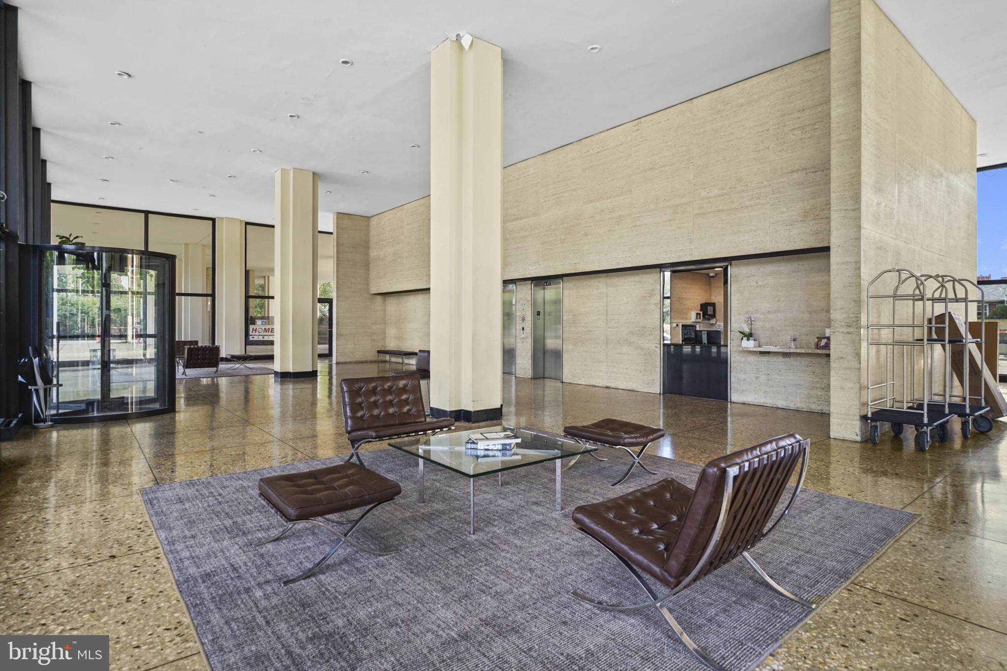4000 North Charles Street, Unit 706 Baltimore, MD 21218 - Photo 21 of 23 a living room with furniture and a floor to ceiling window