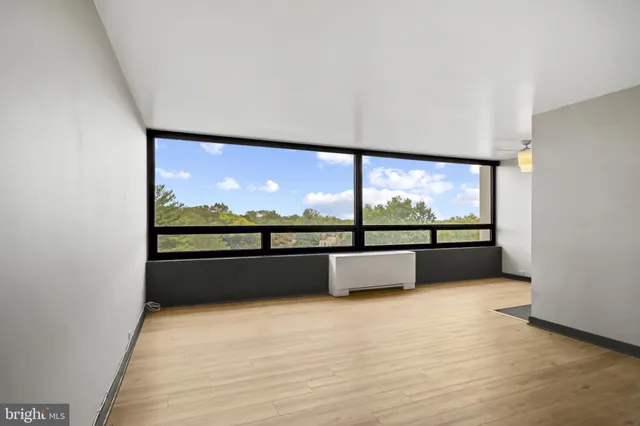 a view of an empty room with a large window