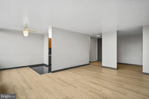 a view of an empty room with wooden floor