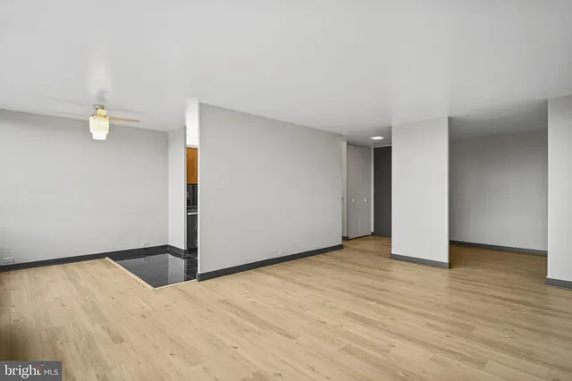 a view of an empty room with wooden floor