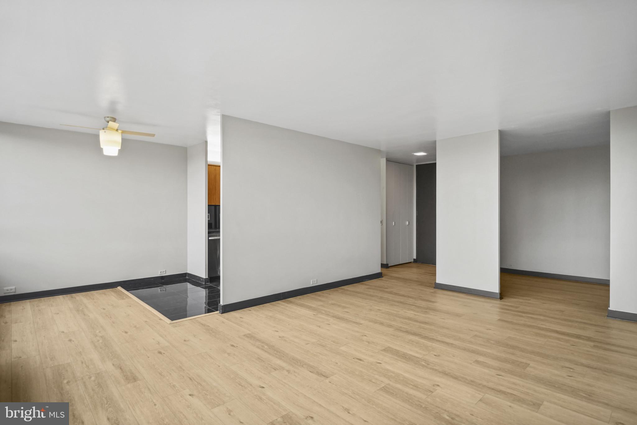 4000 North Charles Street, Unit 706 Baltimore, MD 21218 - Photo 4 of 23 a view of an empty room with wooden floor