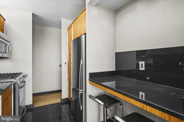 a kitchen with granite countertop a sink and a stove
