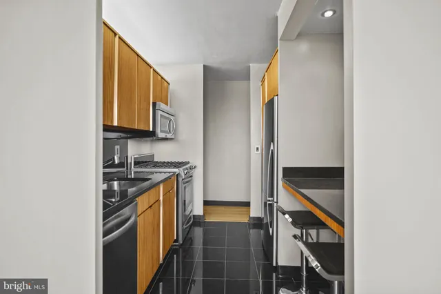 a kitchen with stainless steel appliances granite countertop a stove and a refrigerator