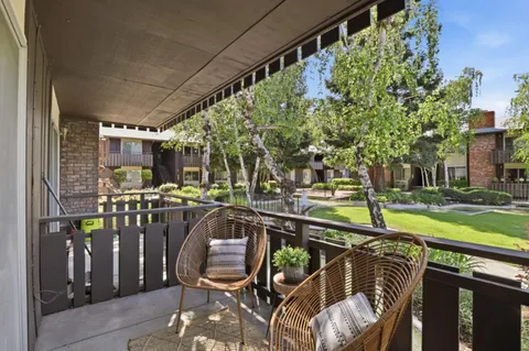 a view of a chairs and table in patio