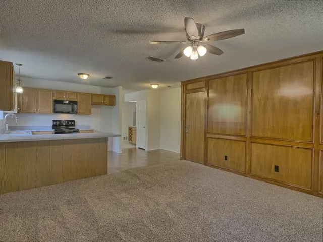 a view of kitchen with refrigerator and window