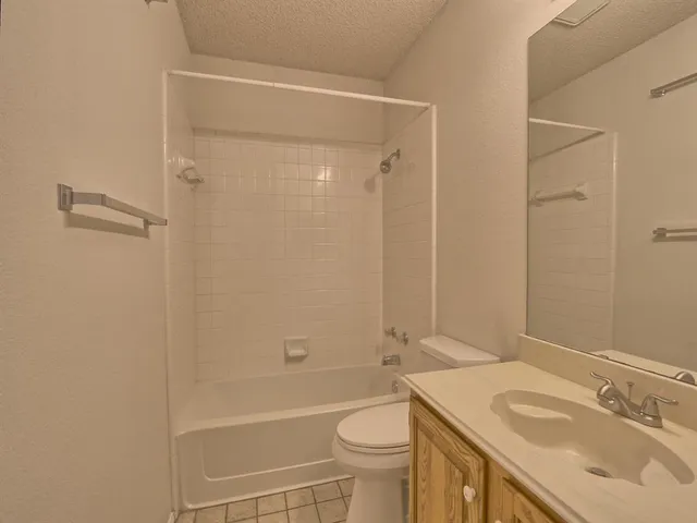 an empty room with a chandelier fan