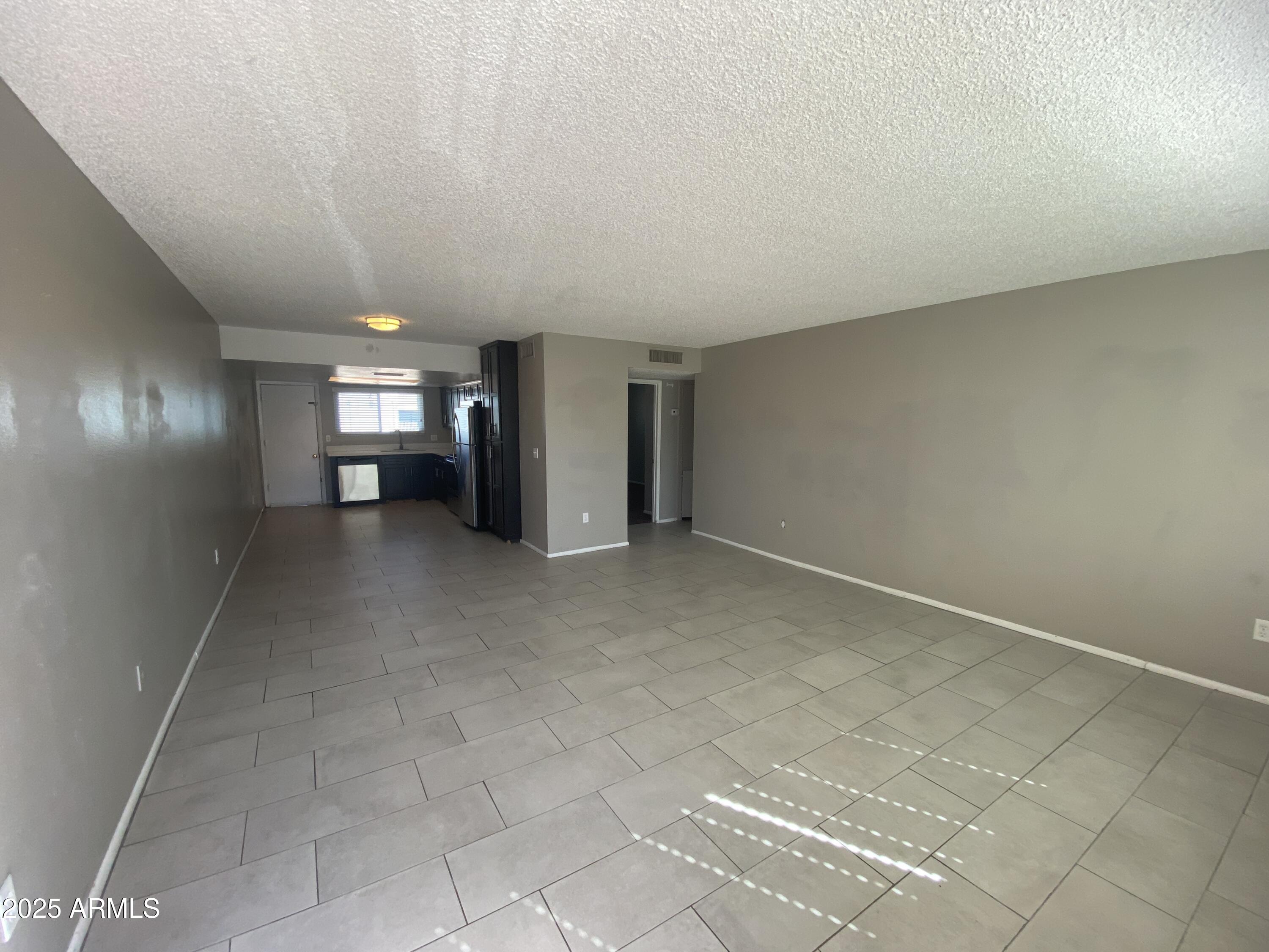 8122 North 33rd Avenue, Unit 3 Phoenix, AZ 85051 - Photo 3 of 11 en empty room with windows
