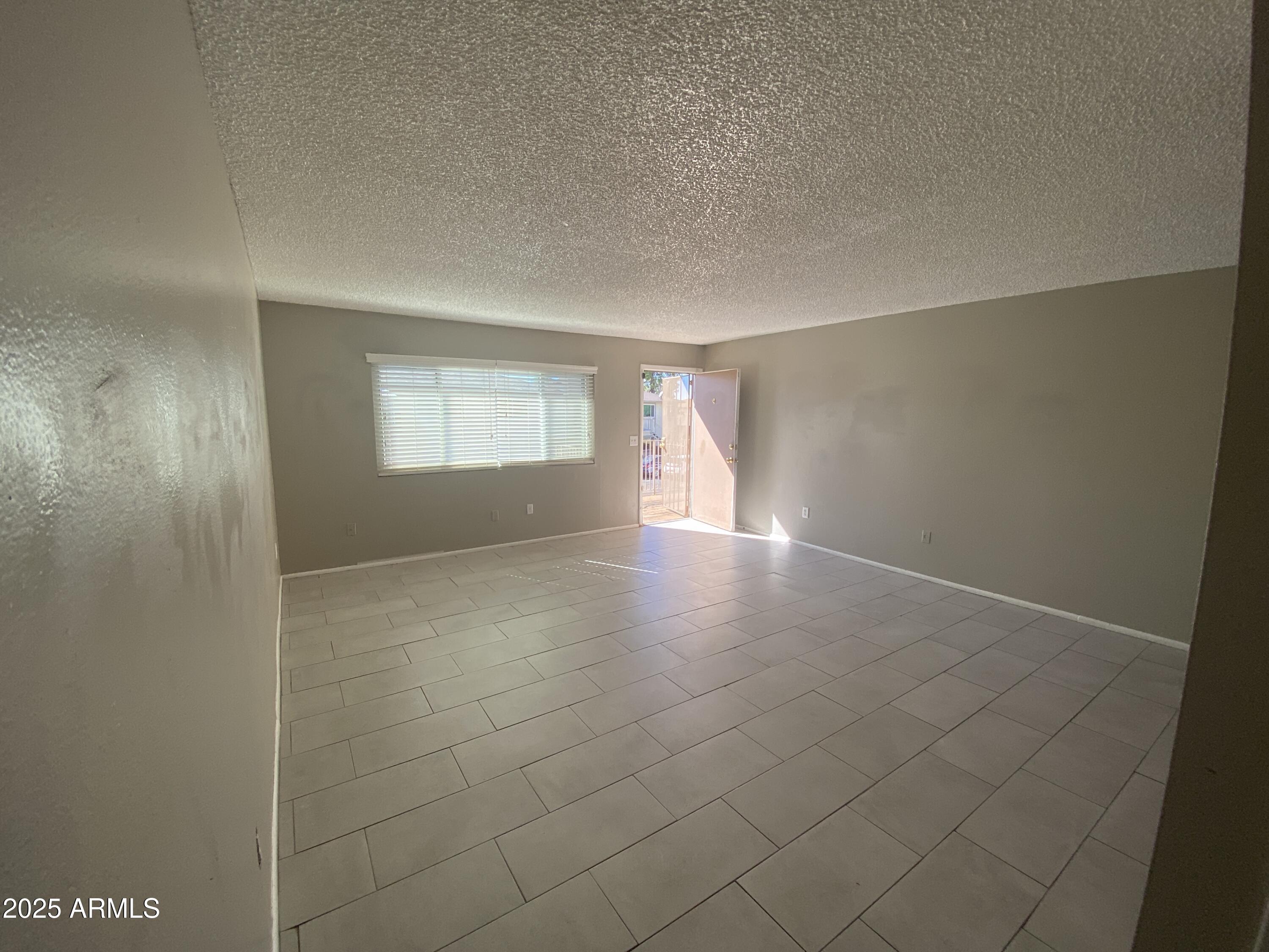 8122 North 33rd Avenue, Unit 3 Phoenix, AZ 85051 - Photo 4 of 11 a view of an empty room and window