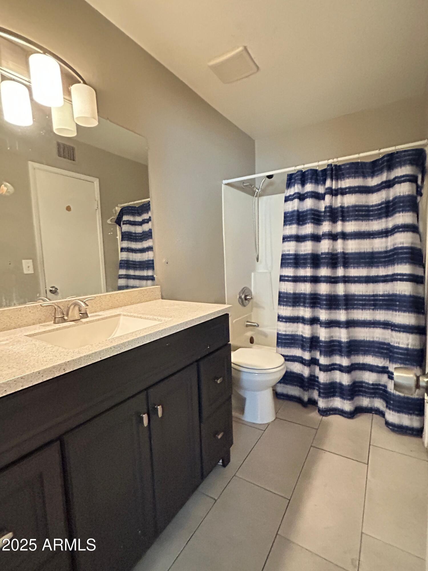 8122 North 33rd Avenue, Unit 3 Phoenix, AZ 85051 - Photo 5 of 11 a bathroom with a sink a toilet and shower