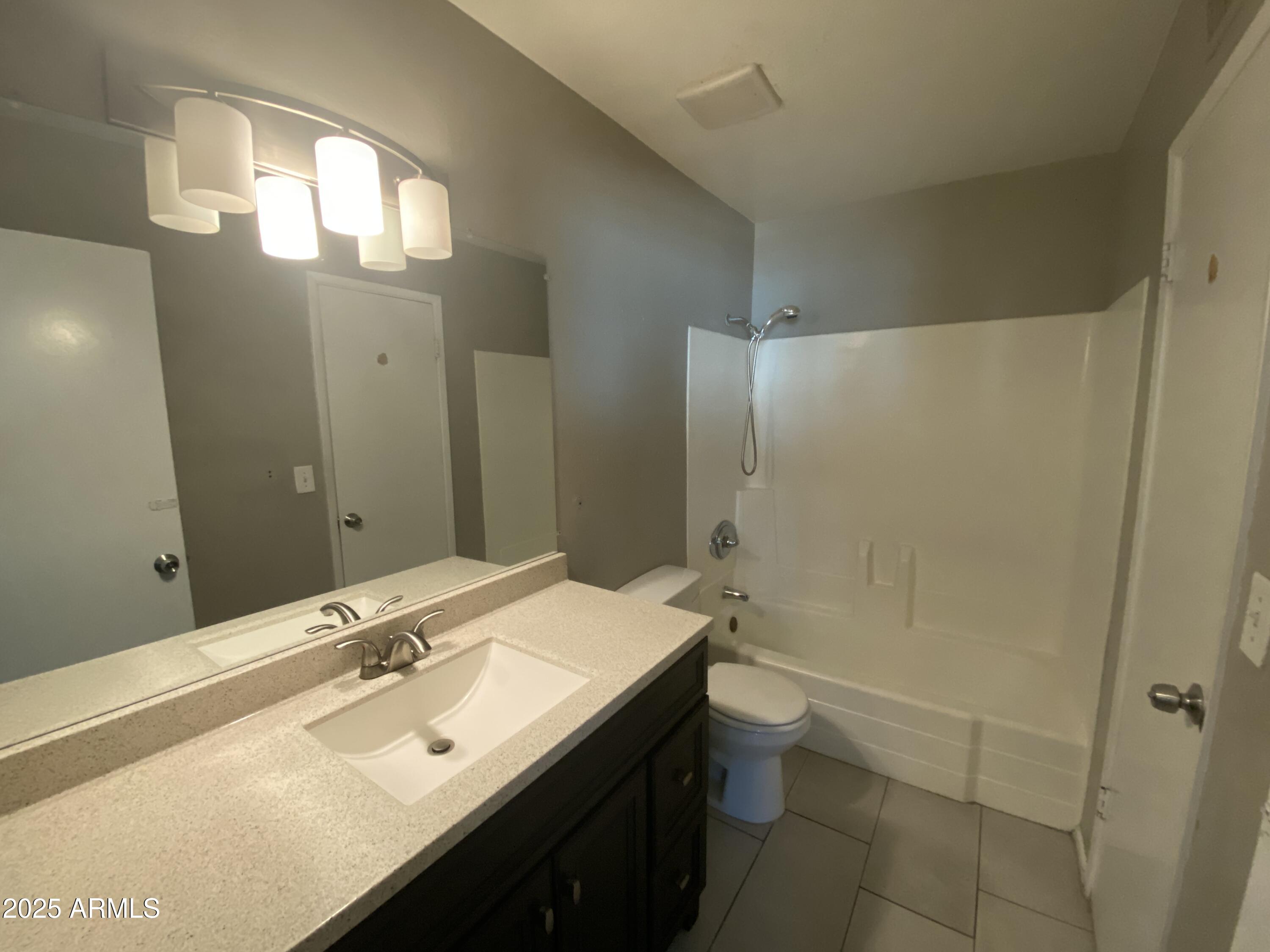 8122 North 33rd Avenue, Unit 3 Phoenix, AZ 85051 - Photo 6 of 11 a bathroom with a sink a toilet and shower