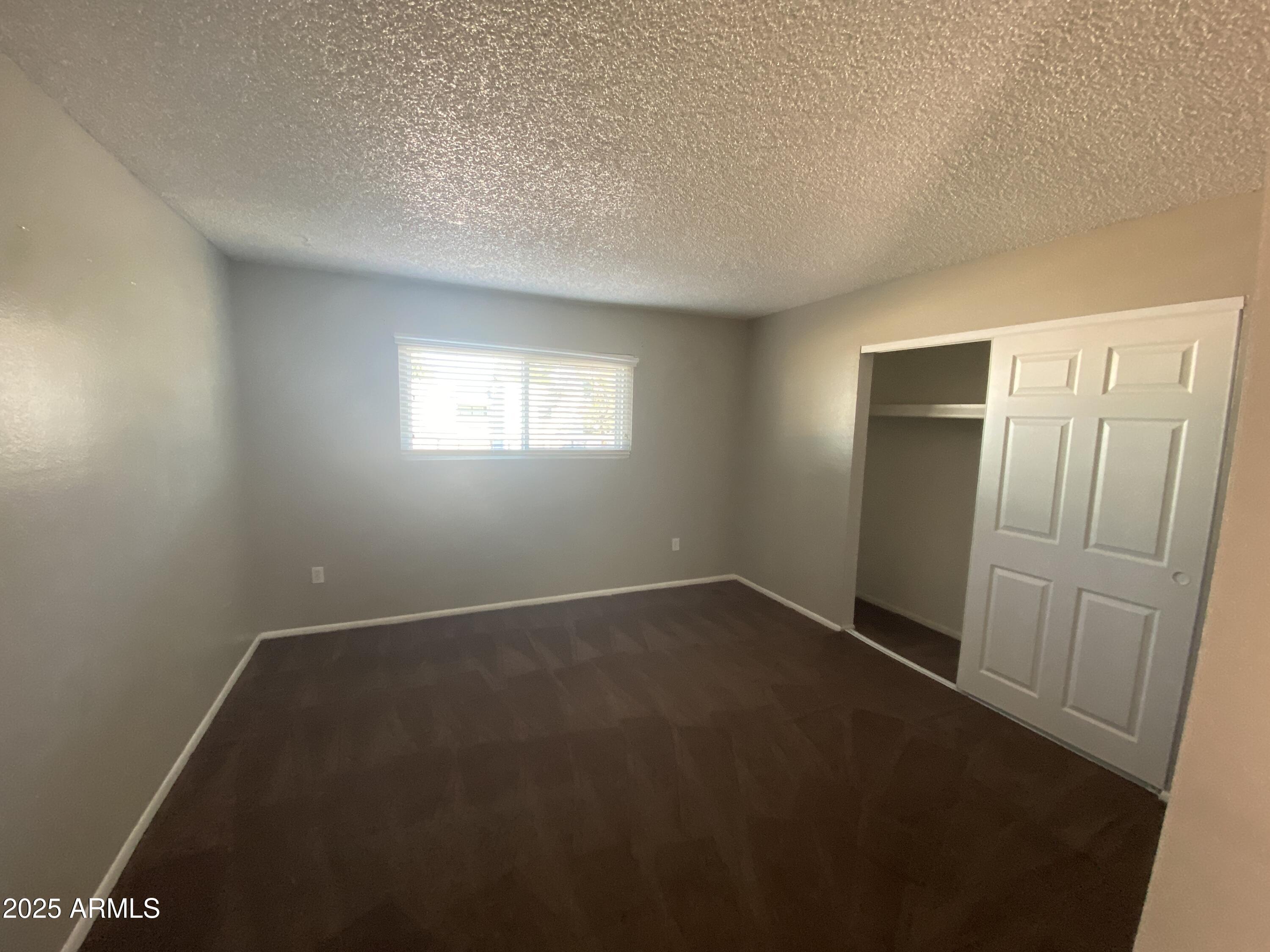 8122 North 33rd Avenue, Unit 3 Phoenix, AZ 85051 - Photo 7 of 11 an empty room with windows