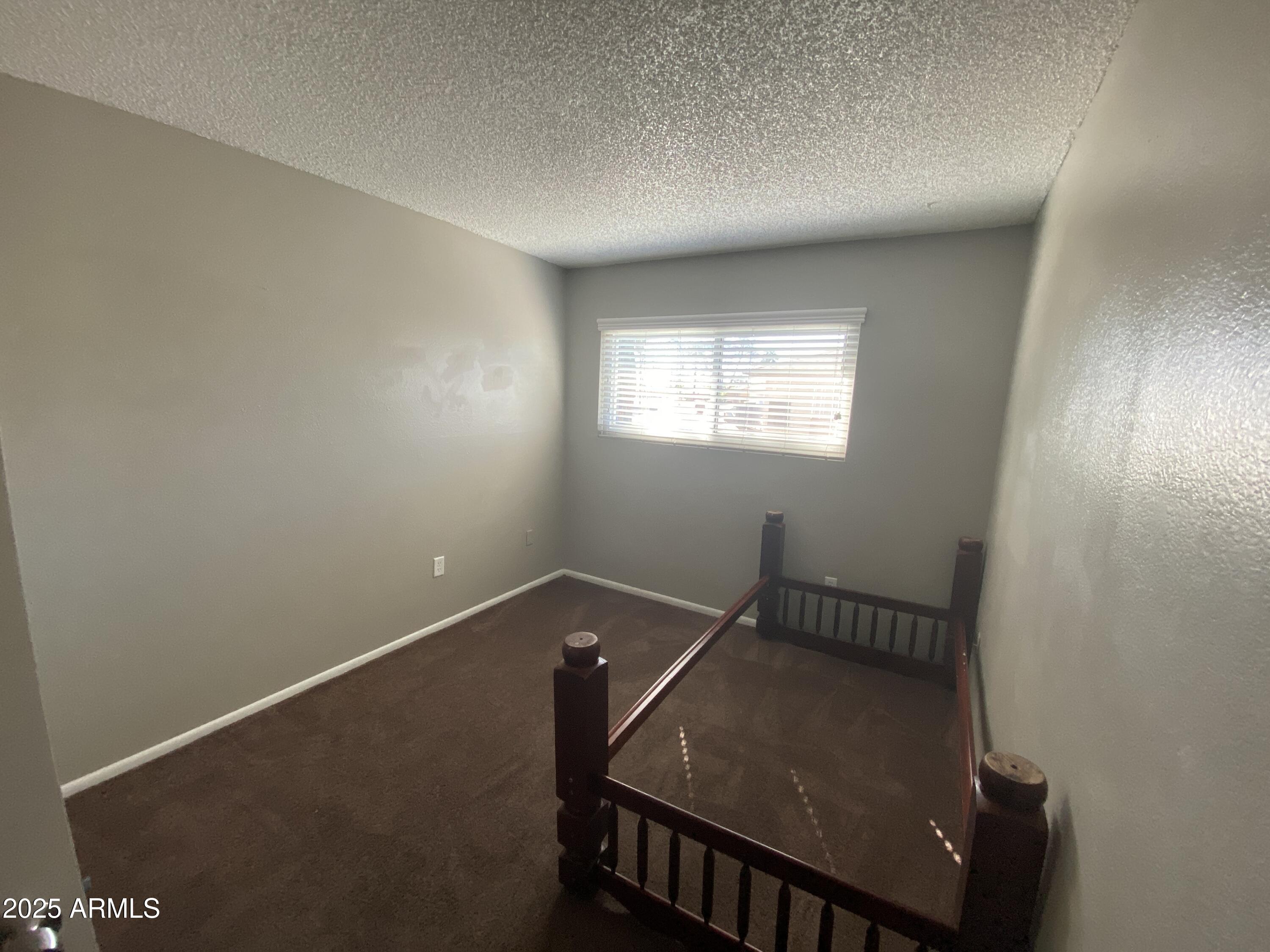 8122 North 33rd Avenue, Unit 3 Phoenix, AZ 85051 - Photo 8 of 11 an empty room with windows