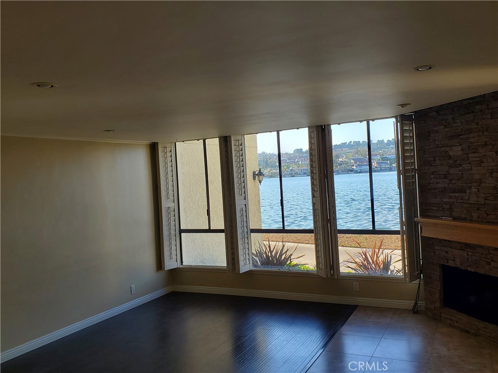 27795 Rota Mission Viejo, CA 92692 - Photo 12 of 27 an empty room with wooden floor and windows