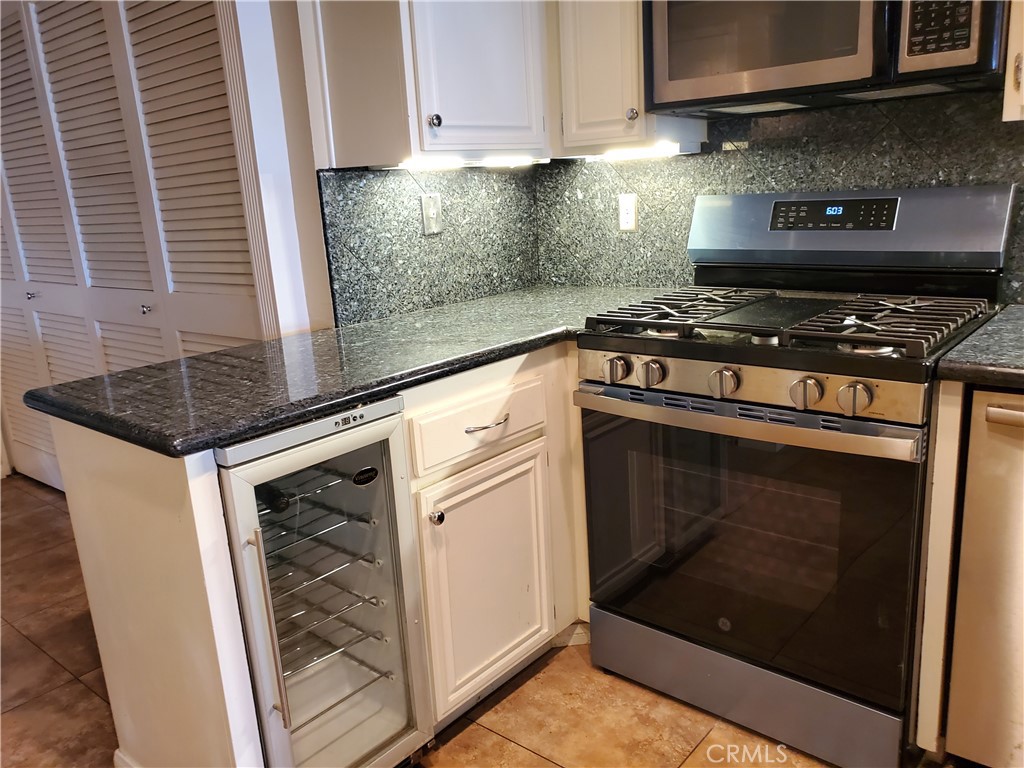 27795 Rota Mission Viejo, CA 92692 - Photo 15 of 27 a kitchen with granite countertop a stove and a microwave