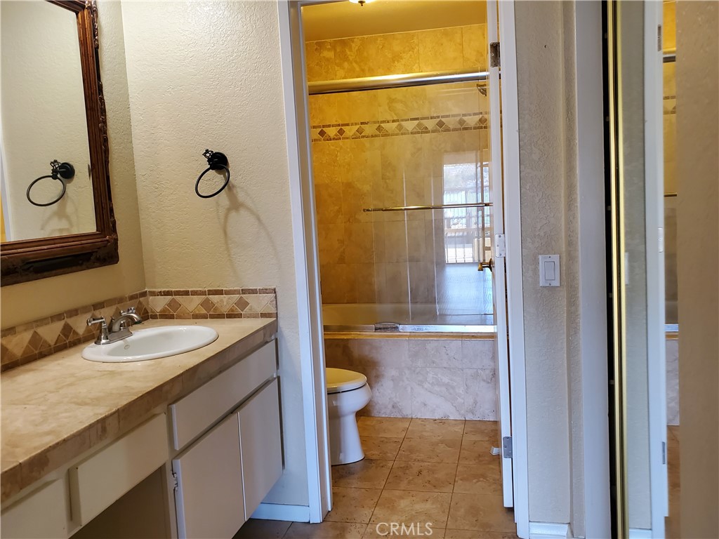 27795 Rota Mission Viejo, CA 92692 - Photo 17 of 27 a bathroom with a granite countertop sink toilet and shower
