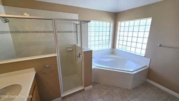 a room with pool table and windows