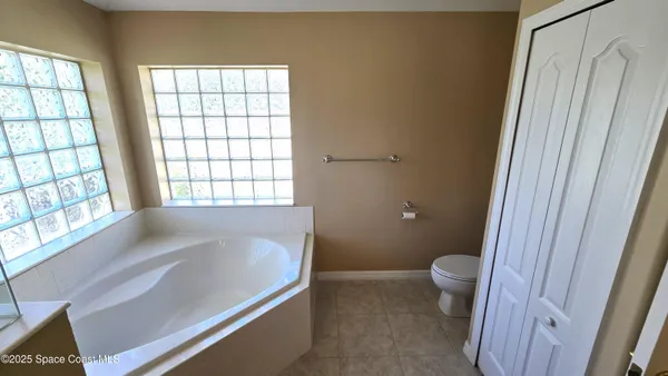 a bathroom with a bathtub and toilet