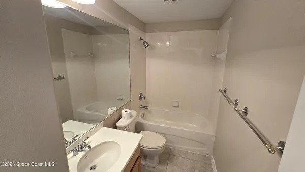 a white toilet sitting next to a bath tub shower