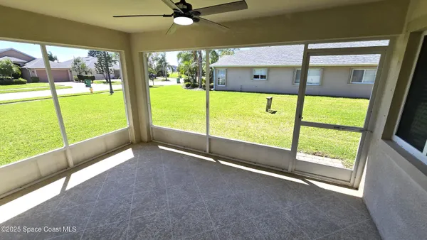 a view of an empty room with a floor to ceiling window and an outdoor view