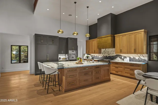 a kitchen with a sink and chairs