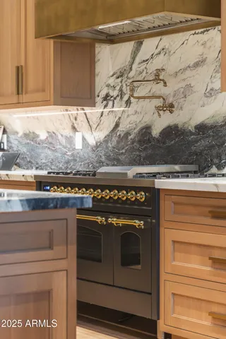 a stove top oven sitting inside of a kitchen