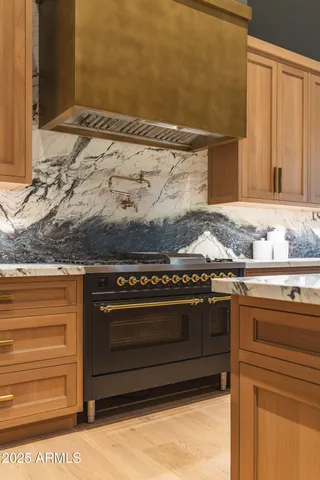 a stove top oven sitting inside of a kitchen