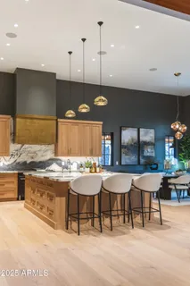 a dining room with furniture a chandelier and wooden floor