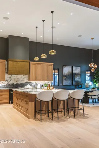 a dining room with furniture a chandelier and wooden floor