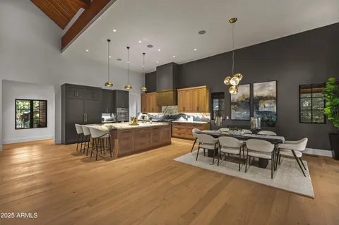 a large kitchen with a table and chairs