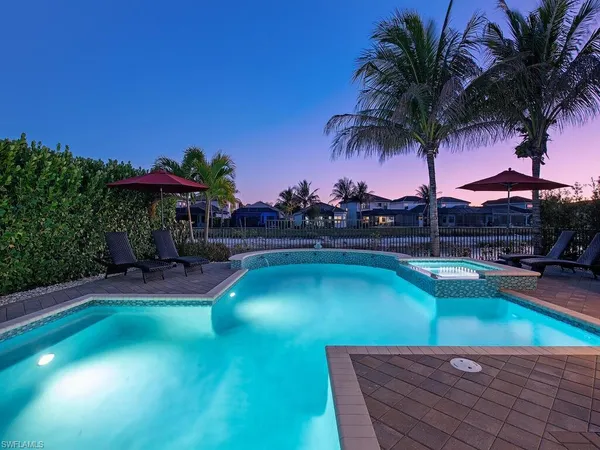 a view of a swimming pool with a table and chairs