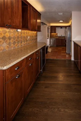 a kitchen with granite countertop a stove and cabinets