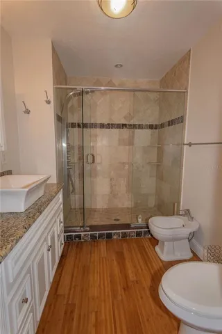 a bathroom with a granite countertop toilet sink and shower