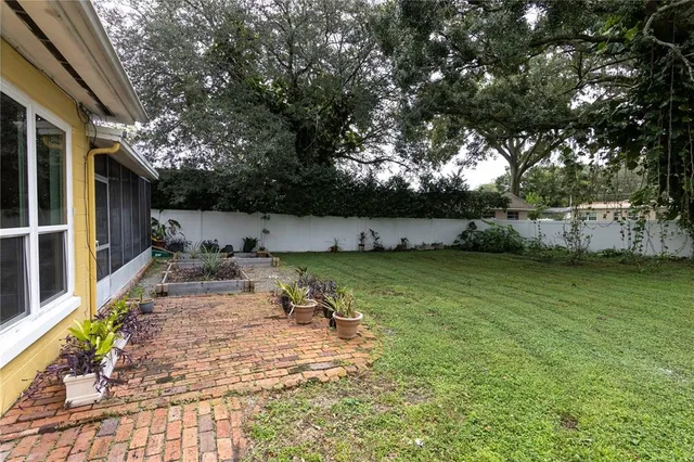 a view of a patio with table and chairs with wooden fence and floor