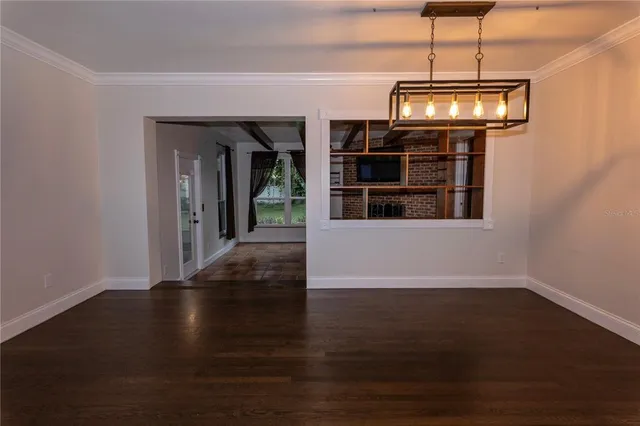 a view of a room with wooden floor cabinets and a window
