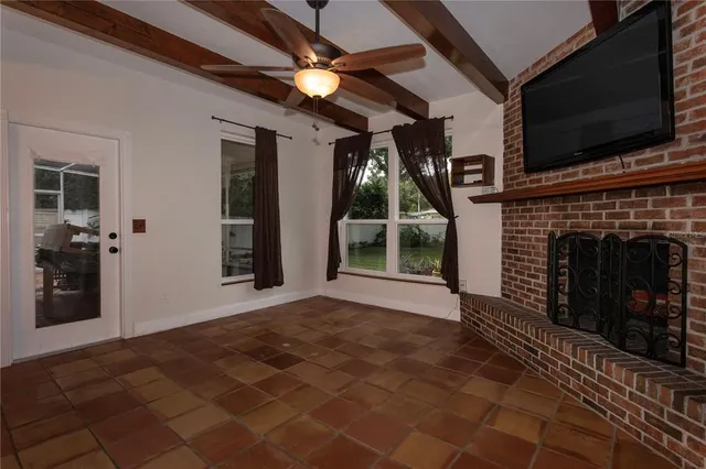 a view of empty room with windows and fireplace