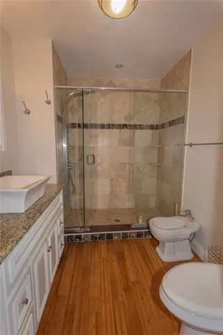 a bathroom with a granite countertop toilet sink and shower