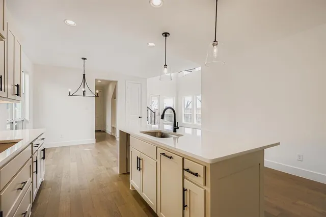 a kitchen with sink cabinets and wooden floor