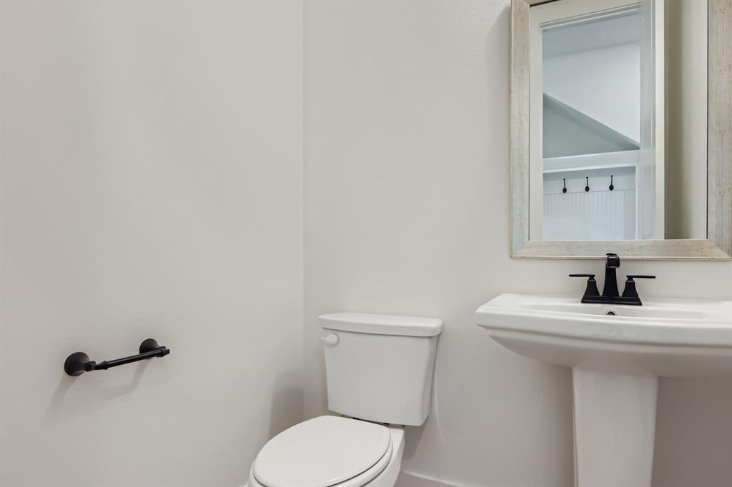 4432 Daisy Lane Prosper, TX 75078 - Photo 13 of 28 a bathroom with a sink toilet and mirror