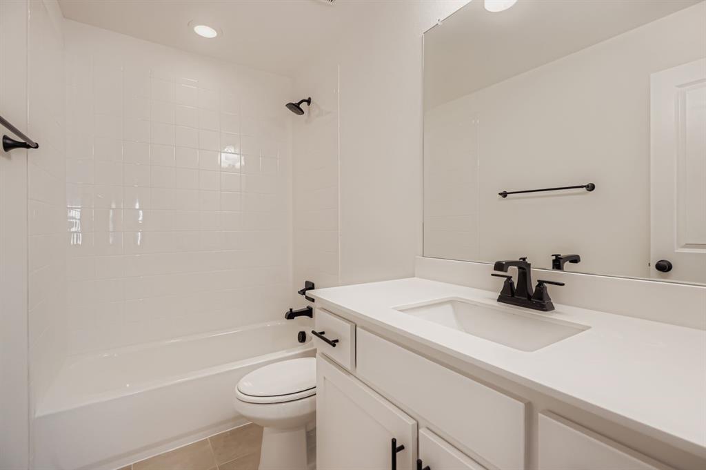 4432 Daisy Lane Prosper, TX 75078 - Photo 22 of 28 a bathroom with a sink a toilet and shower
