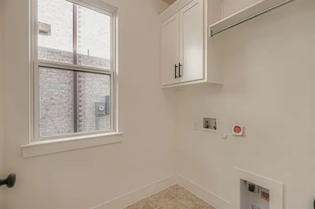 a bathroom with a window and a shower