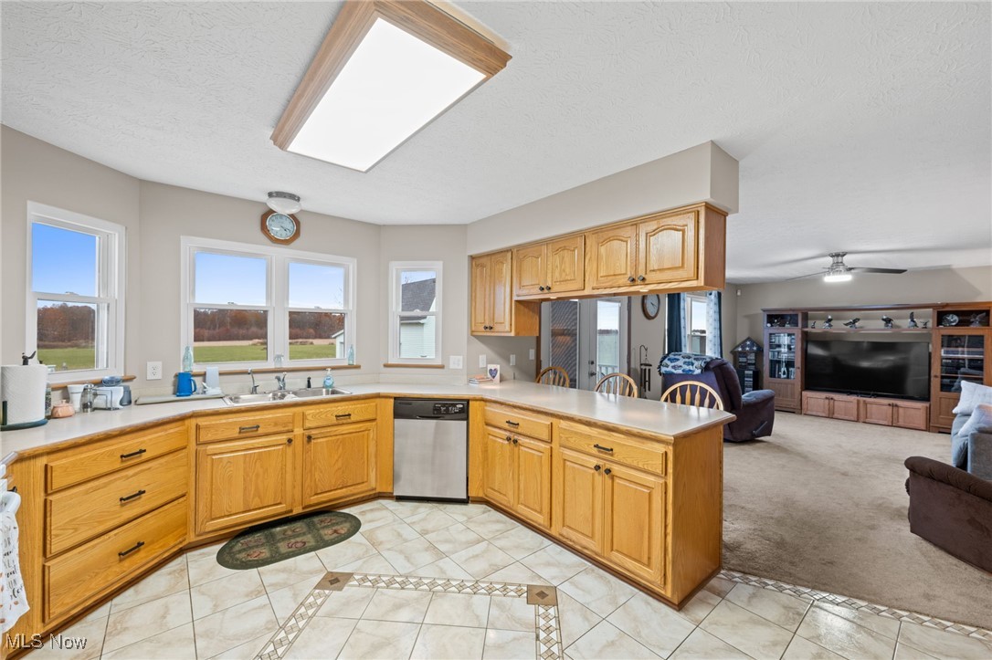 7939 Giddings Road Rootstown, OH 44272 - Photo 11 of 41 Kitchen with light tile patterned floors, inlaid floor details, light countertops, light carpet, and a textured ceiling