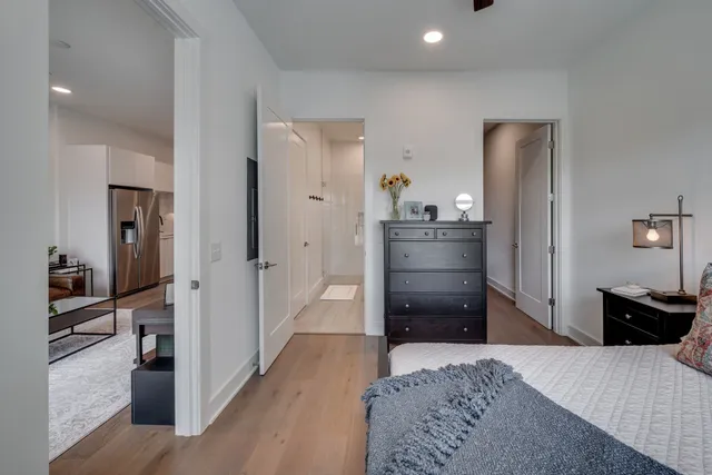 a kitchen with a refrigerator and wooden floor